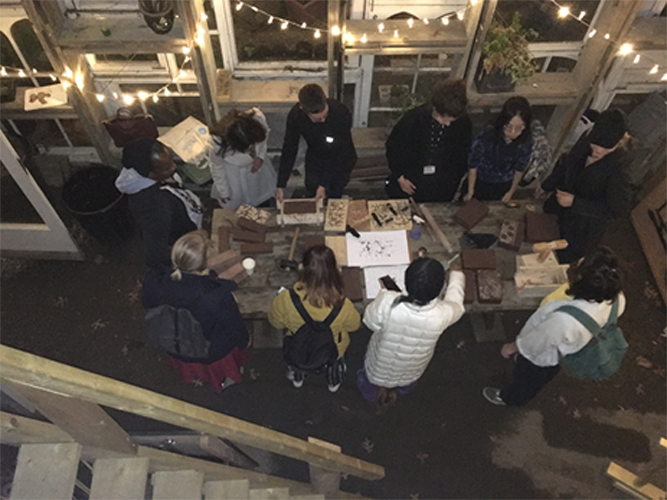 Photo of a candle lit brick decorating workshop